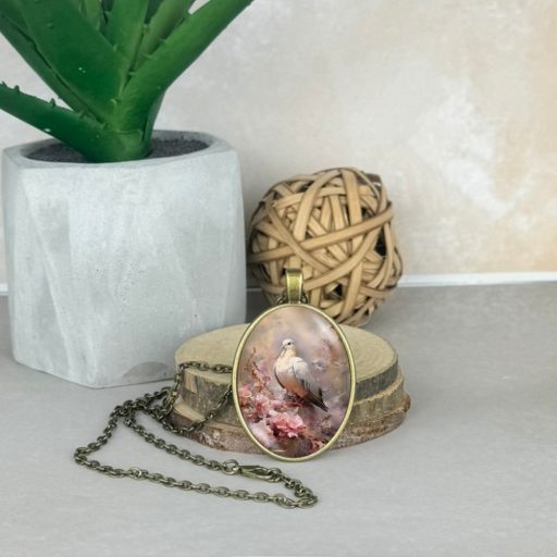 Üveglencsés medál, lánccal-madár